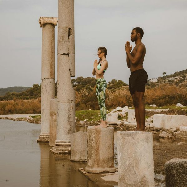 Person standing calmly in a natural setting, suggesting balance and peace.